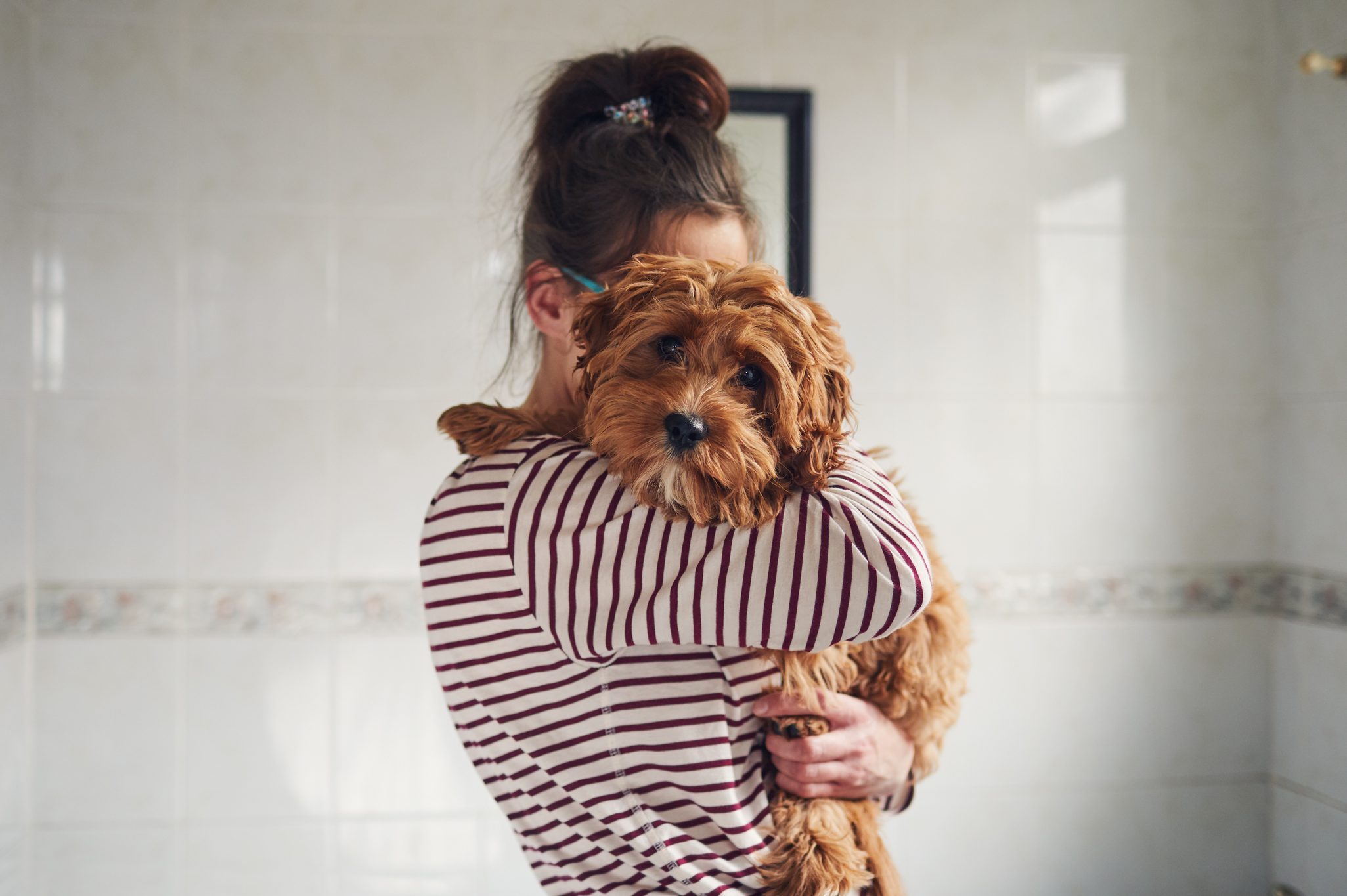 Woman bathing her puppy