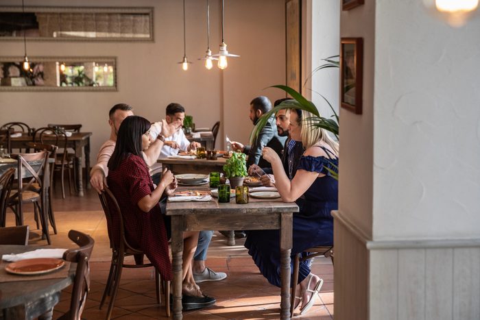 Group of multi ethnic arab friends lunch in a restaurant in Dubai