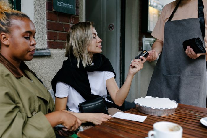 Waitress taking a cashless payment at a German restaurant