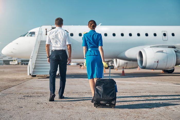 Pilot and stewardess boarding before working trip