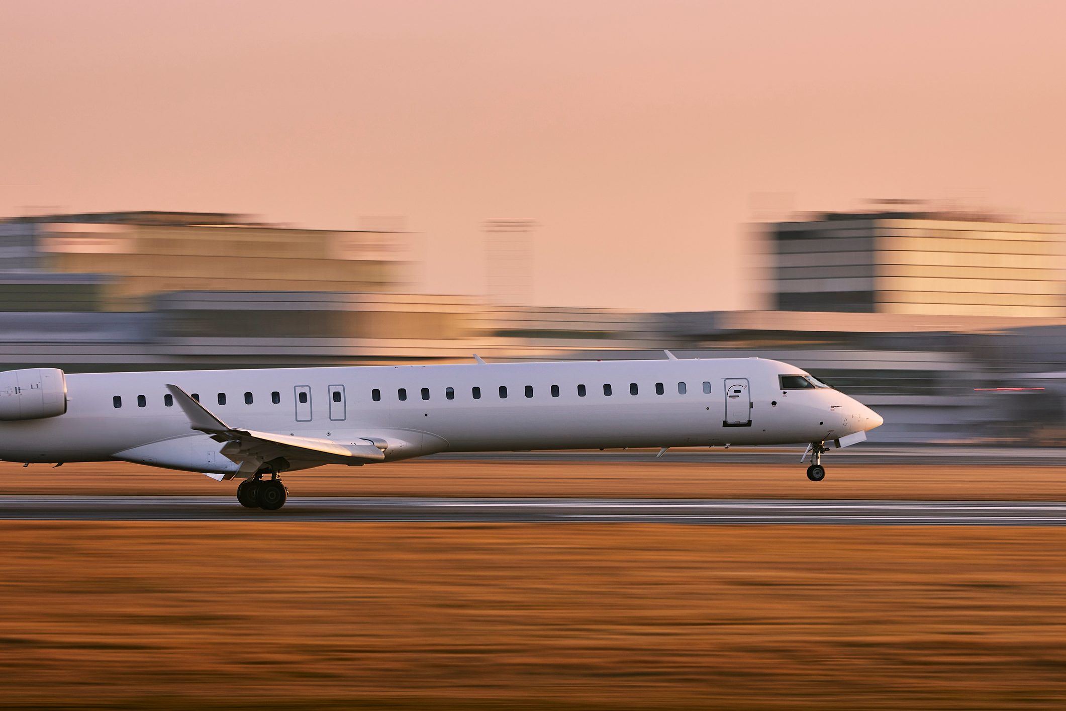 Airplane On Airport Runway Against Sky During Sunset