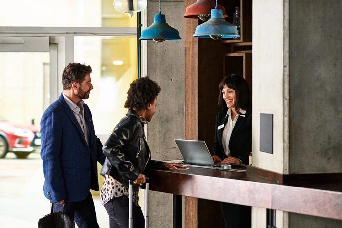 Couple checking in to hotel reception