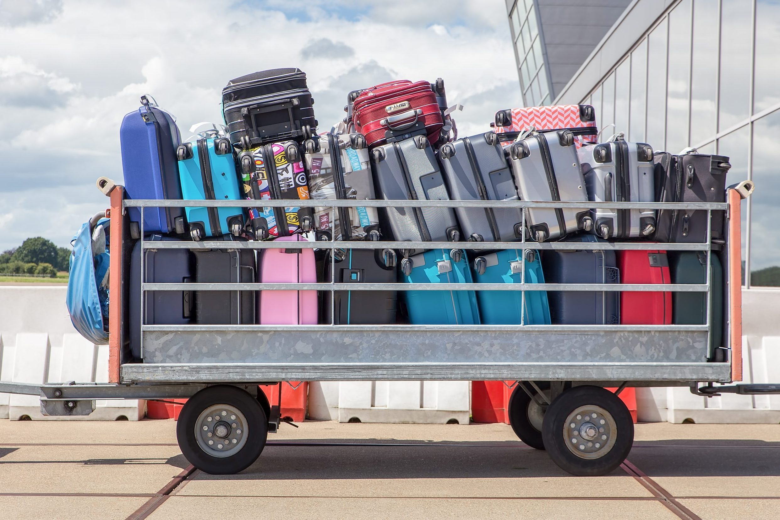 Trailer on airport filled with suitcases