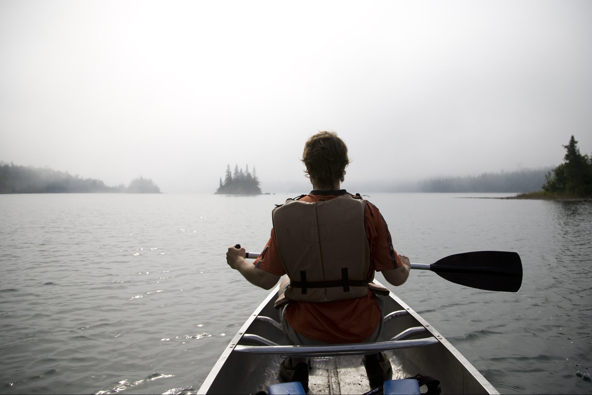 lone paddler in a canoe with a view at Isle Royale, Michigan