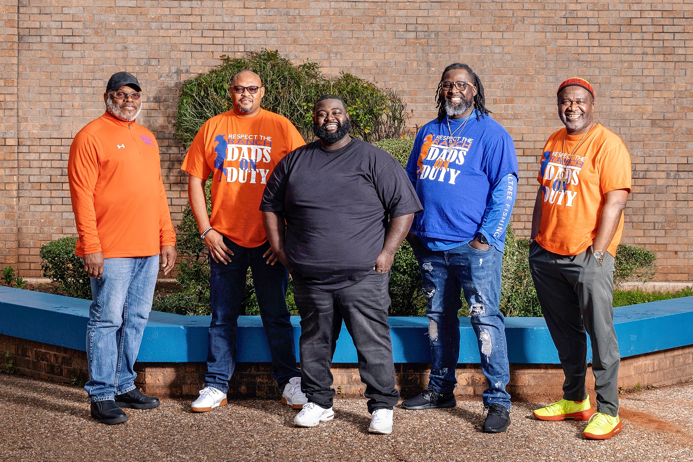 Five members of Dads on Duty standing in front of Southwood High School.