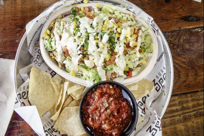 burrito bowl with chips and salsa on the side