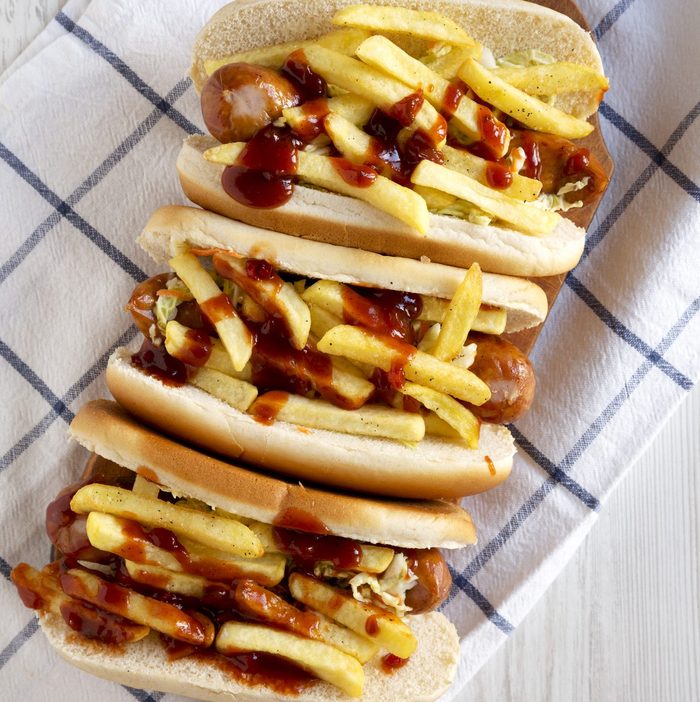 Homemade Cleveland Polish Boy Sandwich on a rustic wooden board on a white wooden background, top view. Flat lay, overhead, from above.