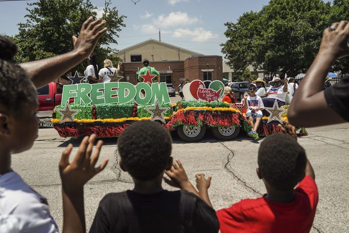 GALVESTON, TX - JUNE 19: Spectators watch Juneteenth Parade commemorating the end of slavery in the United States on June 19, 2021 in Galveston, Texas