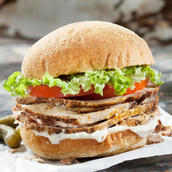 Roast Pork Sandwich with Lettuce, Tomato and Mayo on a Ciabatta Bun