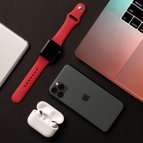 Flat Lay of different apple products on a grey background.