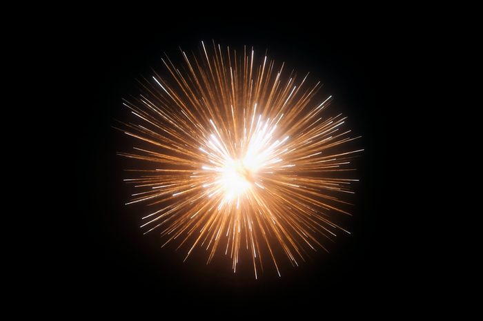 Exploding fireworks against black night sky