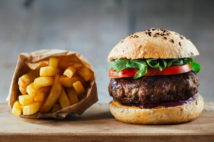 Delicious burgers with beef, tomato, cheese and lettuce