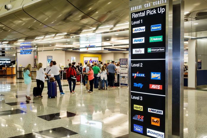 A rental car pick-up sign in the gate area at Miami International Airport.