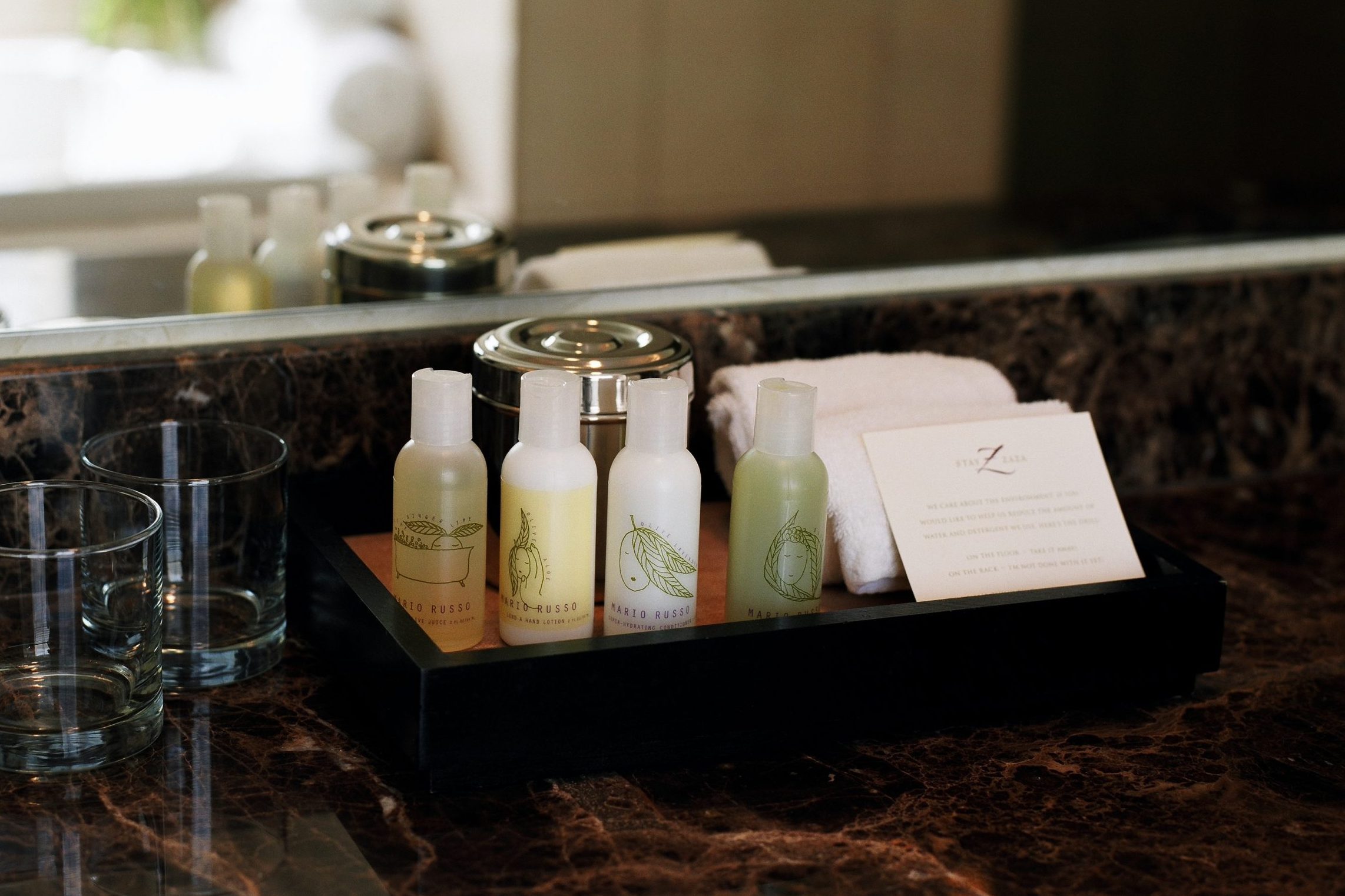 hotel shampoo and condtioner bottles on a tray in the bathroom