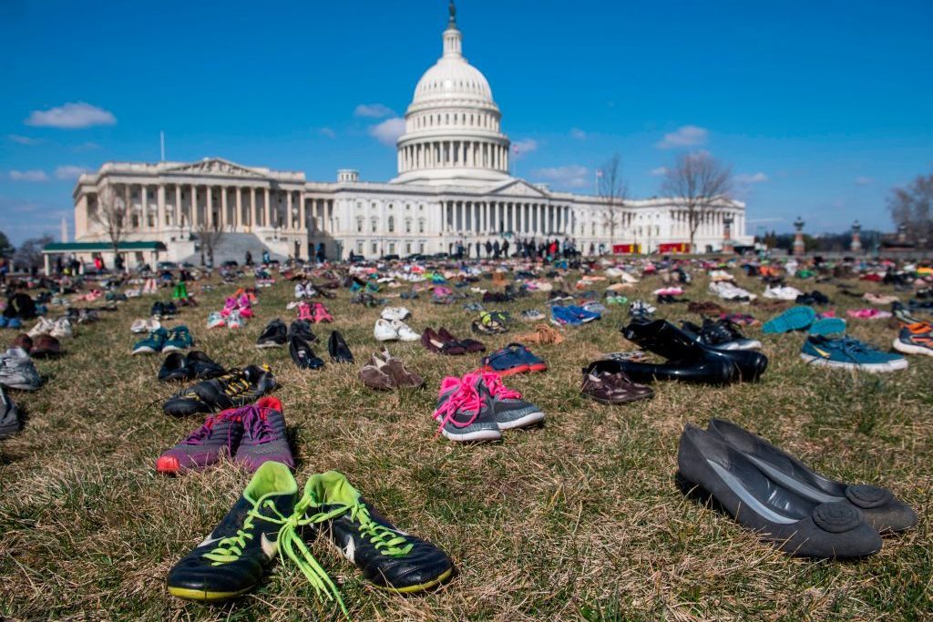 The lawn outside the US Capitol is covered with 7,000 pairs of empty shoes to memorialize the 7,000 children killed by gun violence since the Sandy Hook school shooting, in a display organized by the global advocacy group Avaaz, in Washington, DC, March 13, 2018.