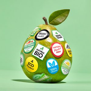 Green pear with stickers