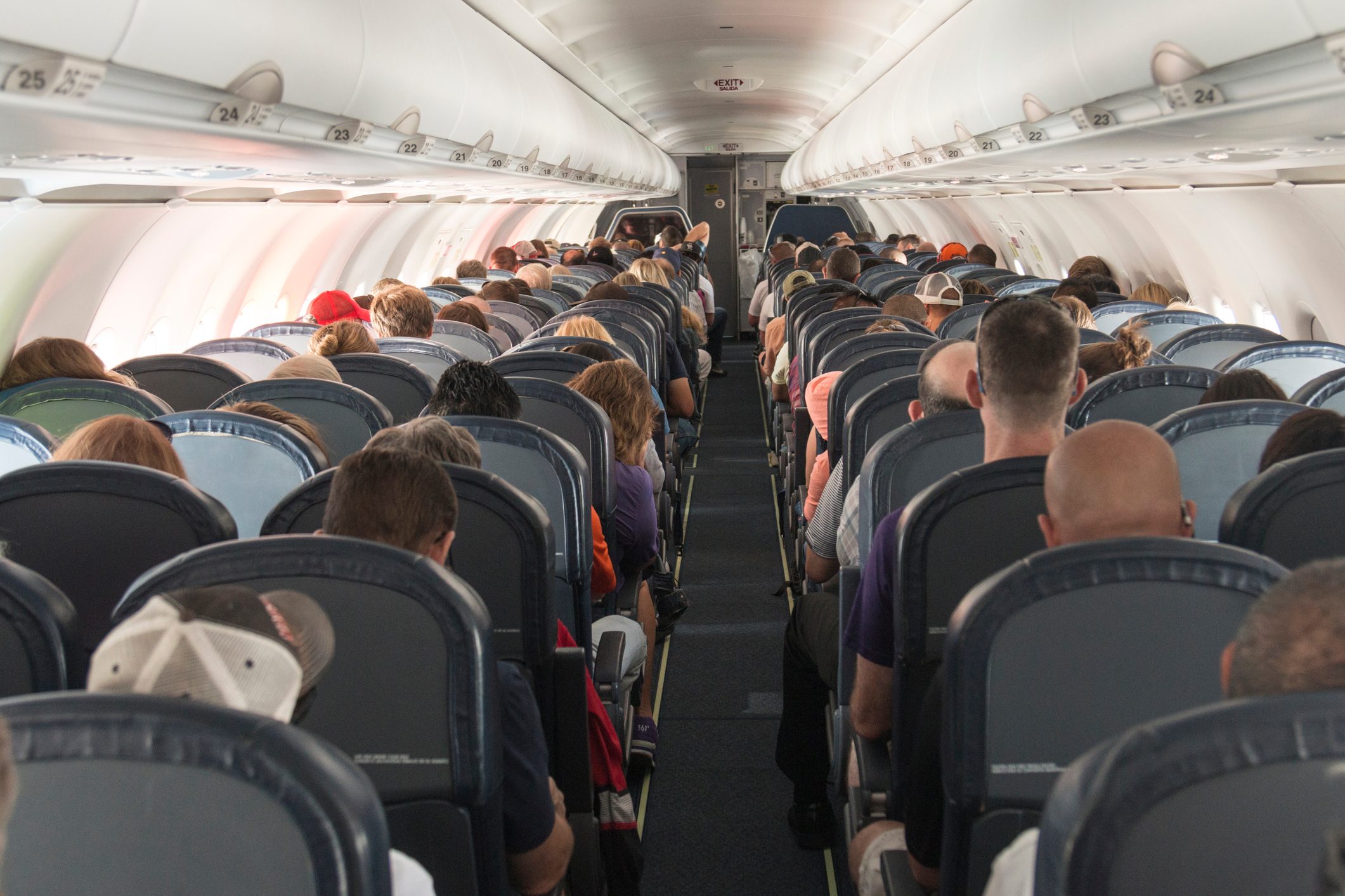 Rear View Of People Sitting In Airplane