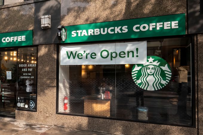 starbucks coffee exterior with a sign on the window that says 