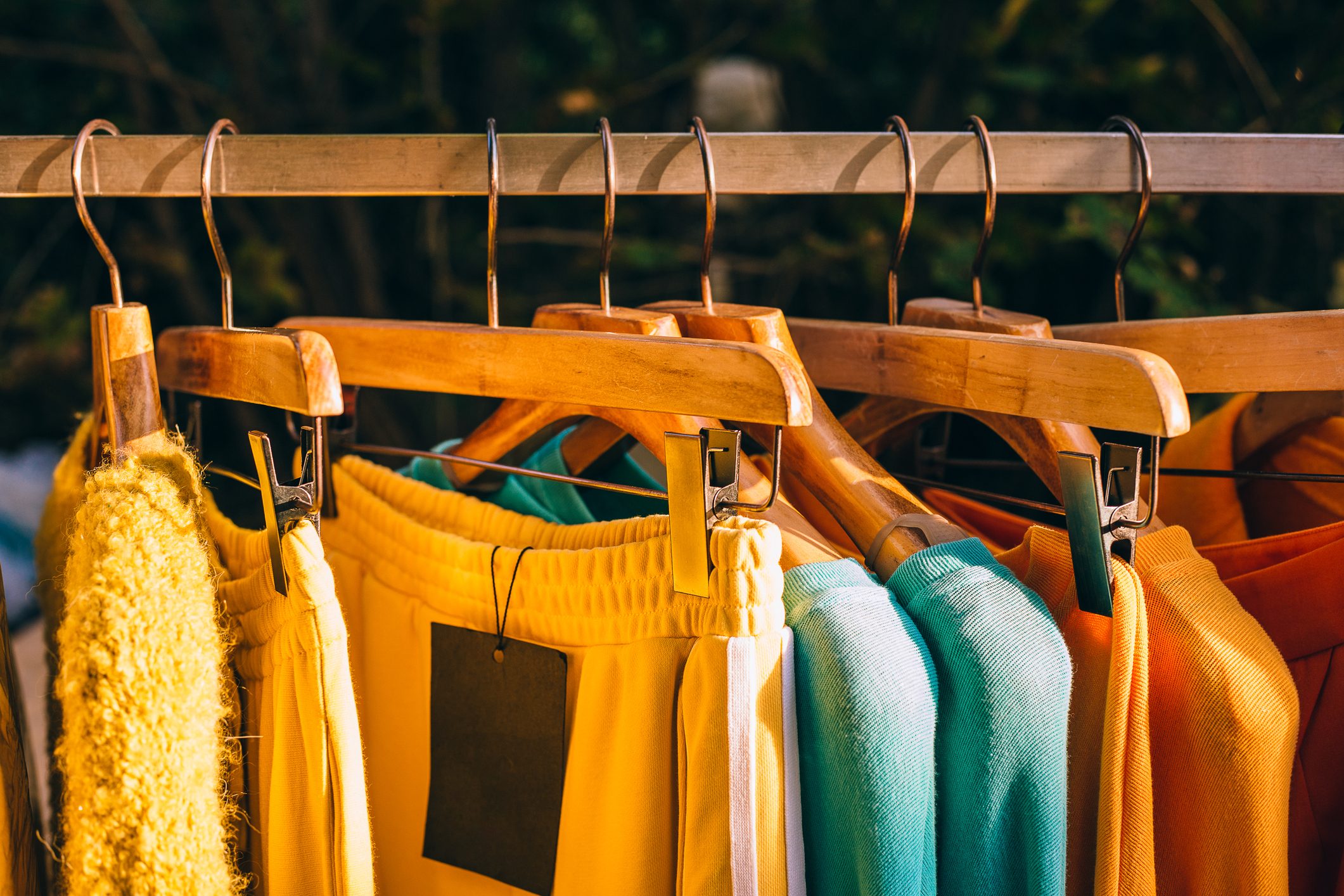 Clothes hang on a shelf in a designer clothes store