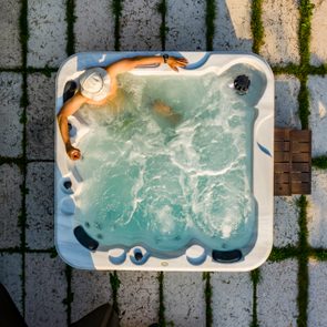 man relaxing in whirlpool at sunny day