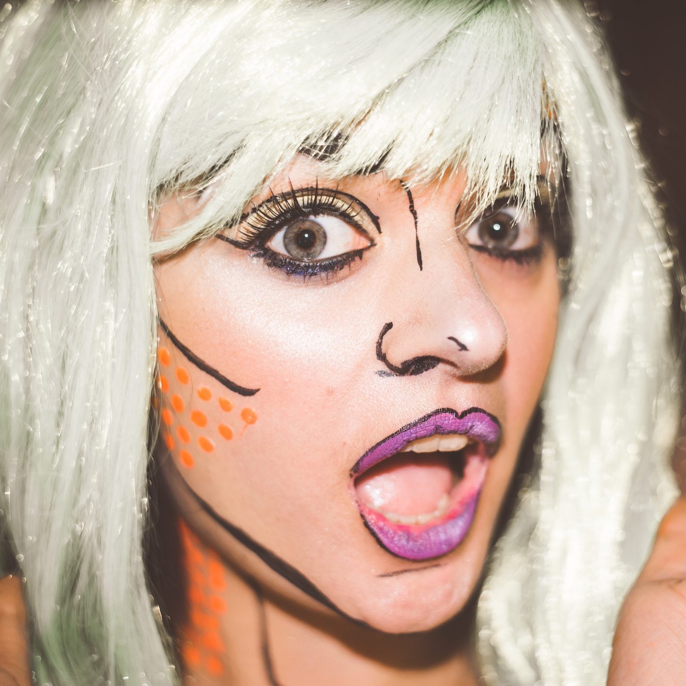 Close-Up Portrait Of Shocked Young Woman Wearing Costume with cartoon character makeup