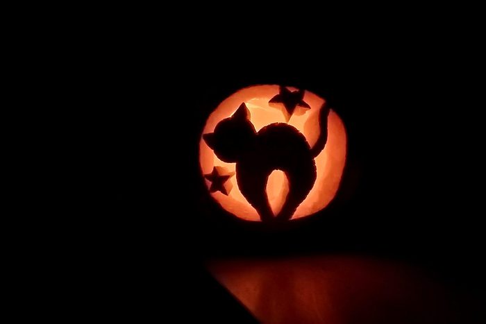 Halloween carved pumpkin glowing in the dark