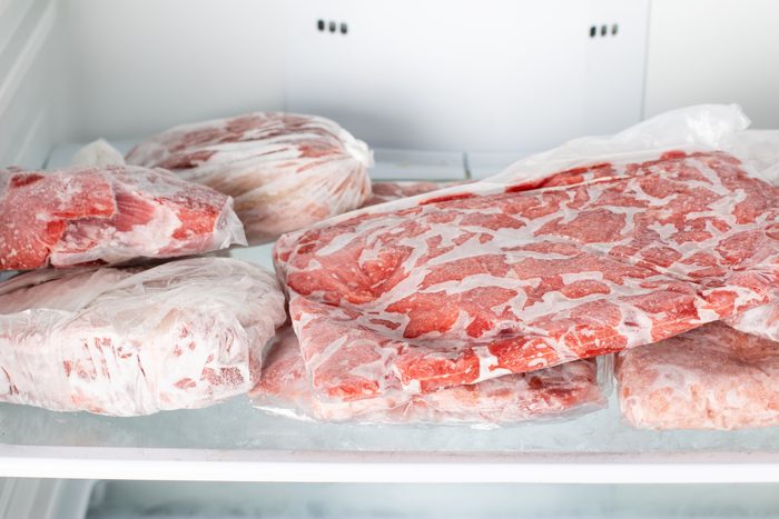 Chicken beef and pork Packed in plastic bags in the white freezer. Frozen raw meat.