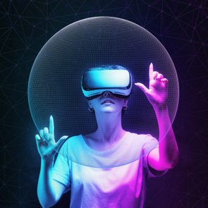 woman in VR glasses creates mesh sphere. Dark background with neon abstracts. The concept of virtual reality and futurism