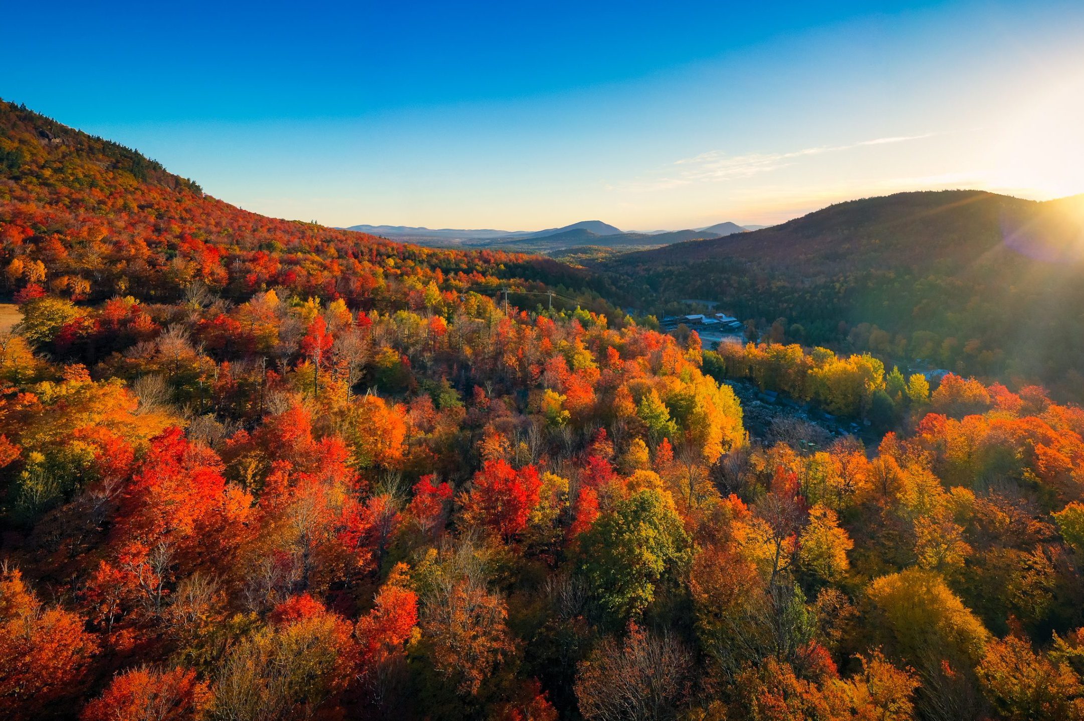 Aerial view of Mountain Forests with Brilliant Fall Colors in Autumn at Sunrise, New England