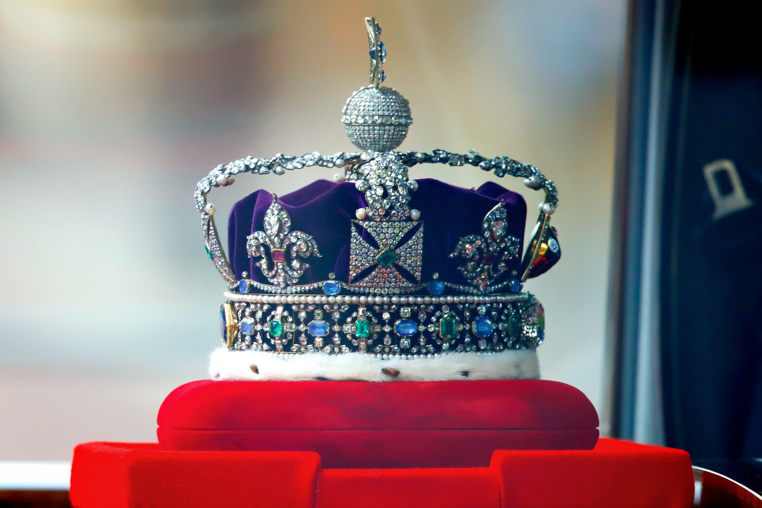 close up of the imperial state crown in a vehicle being driven to the houses of paliament
