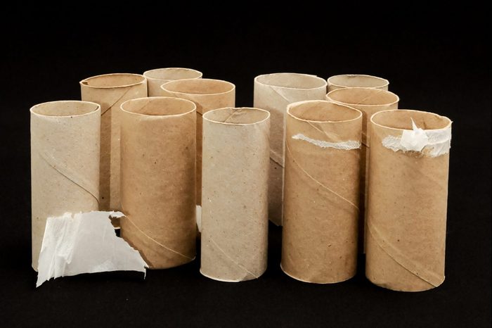 Empty Toilet Paper Rolls on black background