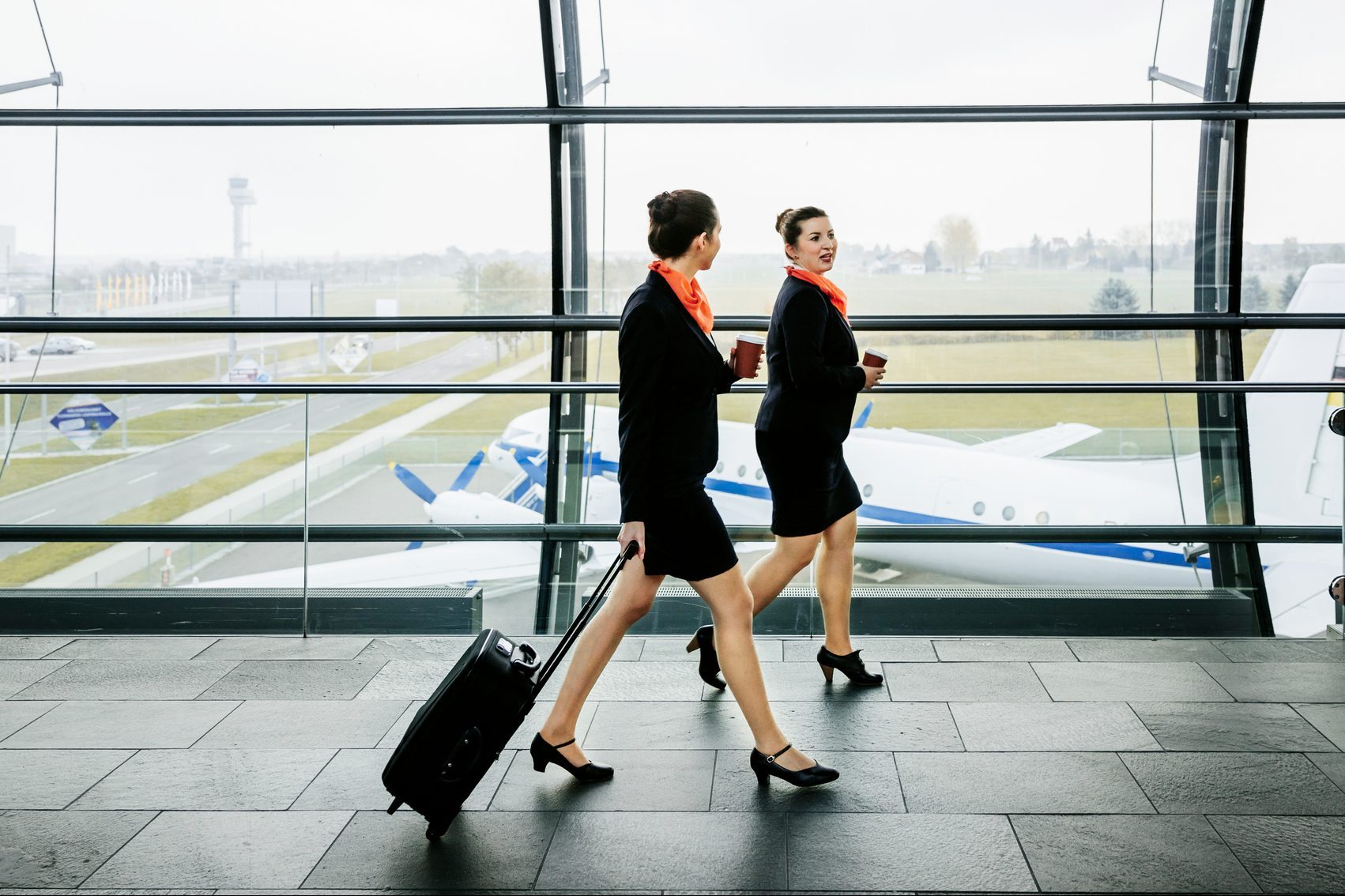 Two flight attendants on the way to their plane
