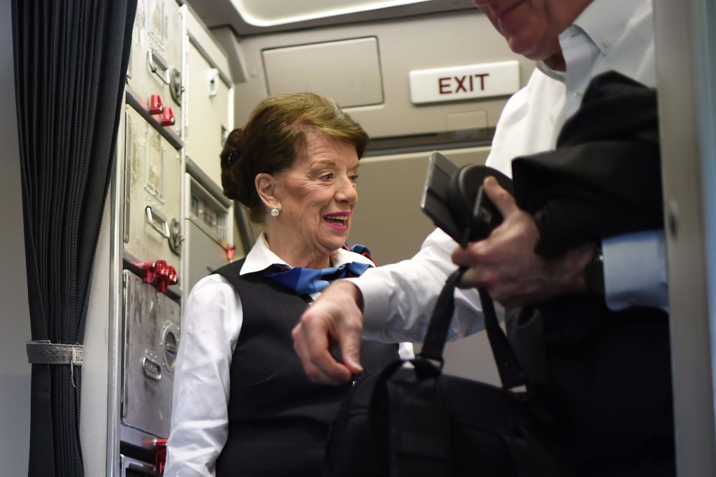 flight attendant greeting passengers