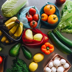 fruits and vegetables spread out on a kitchen counter