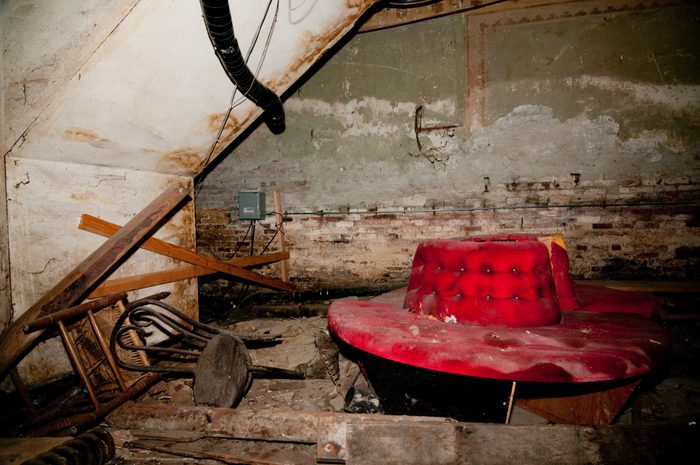 An old red couch in the Historic Seattle Underground late in the day on 1st avenue in Pioneer Square in old seattle