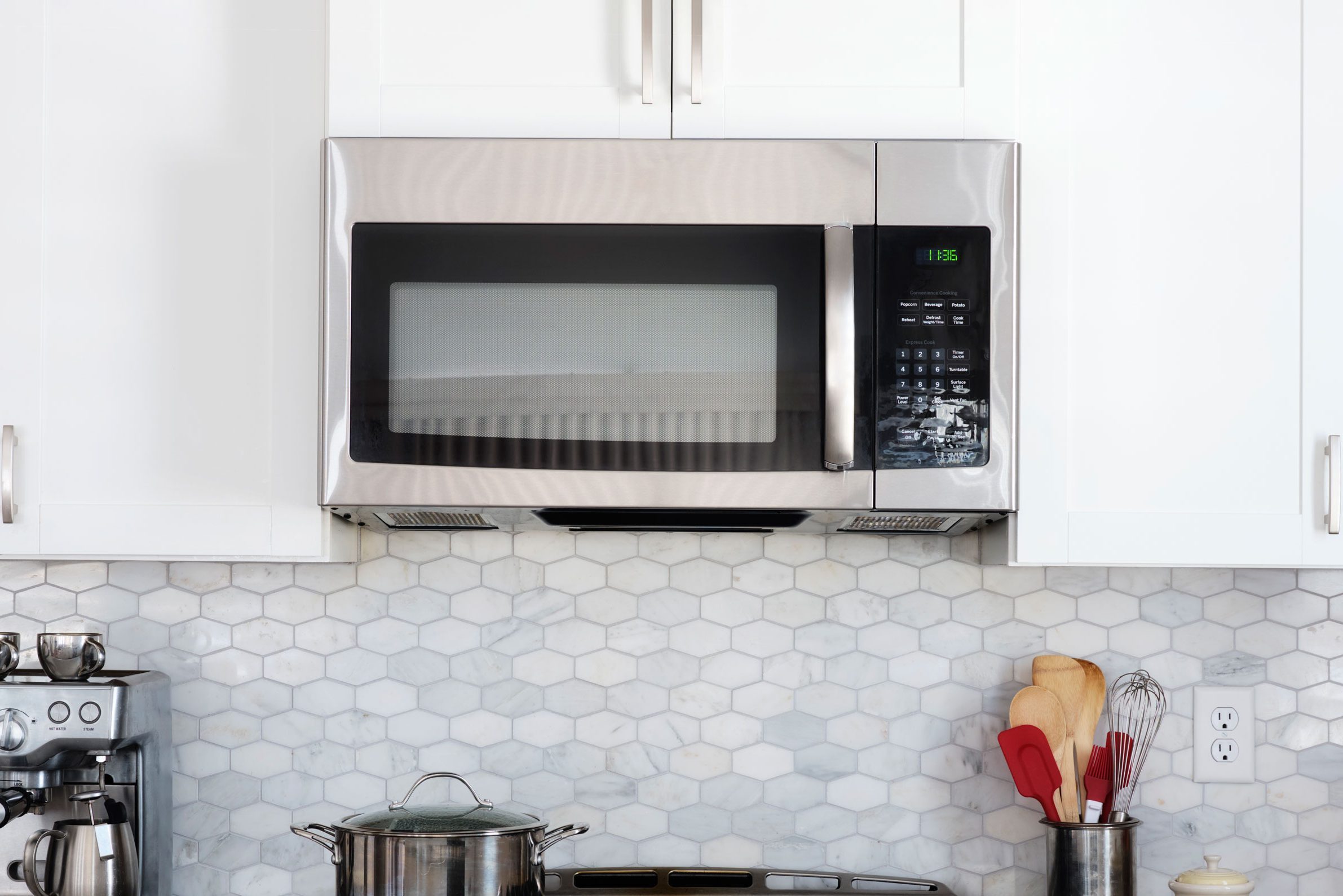 Microwave above a stovetop in a modern kitchen