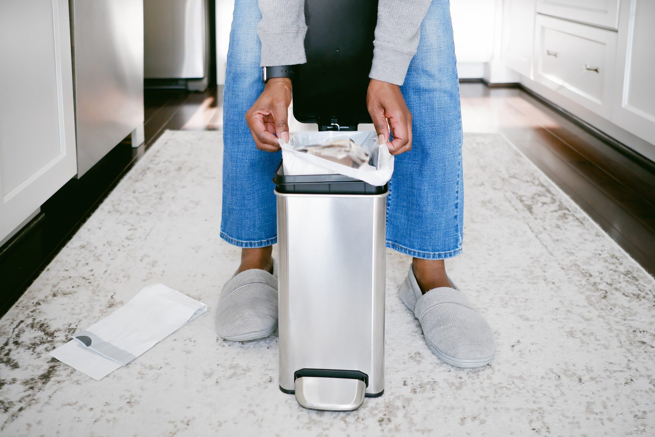 Woman Removes Trash Bag From Can