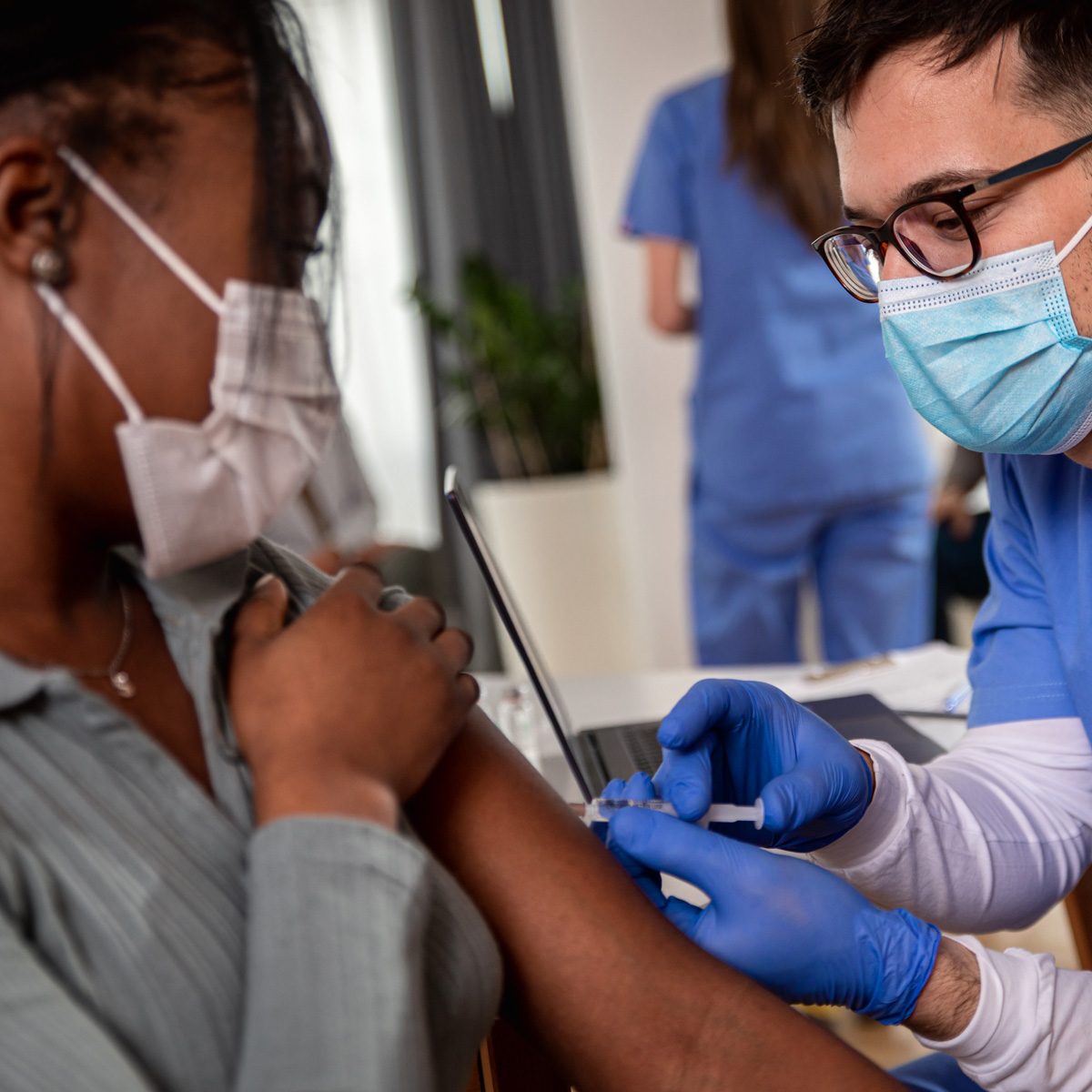 Male Nurse Vaccinating Black Woman Adobestock 413206886 1200x1200