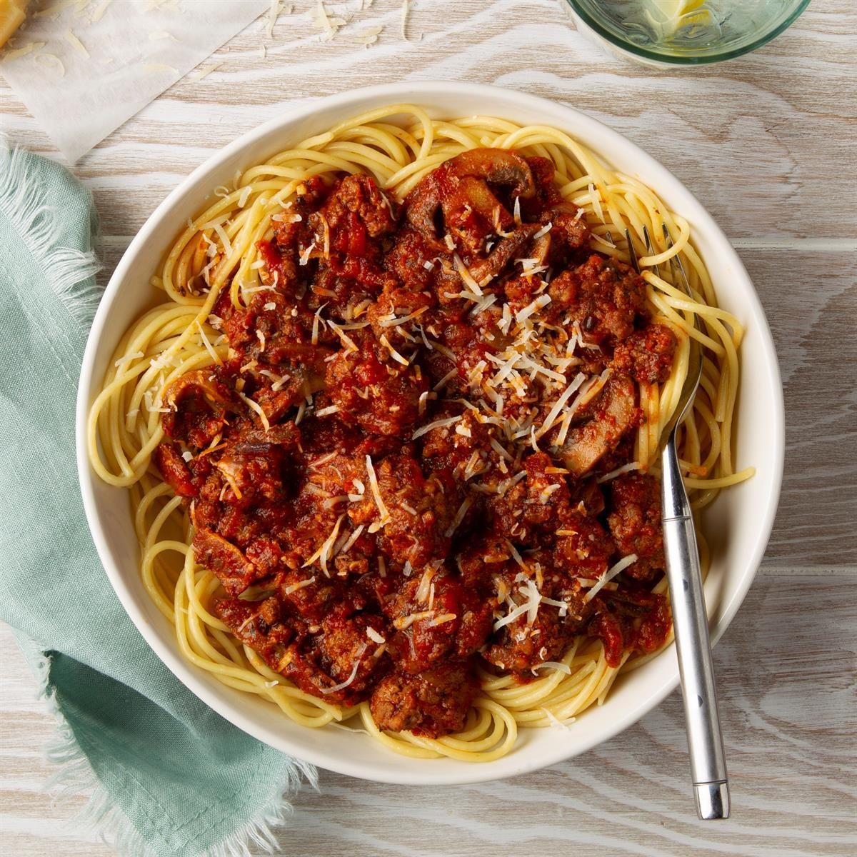 Pasta Napolitana on a wood background with a napkin