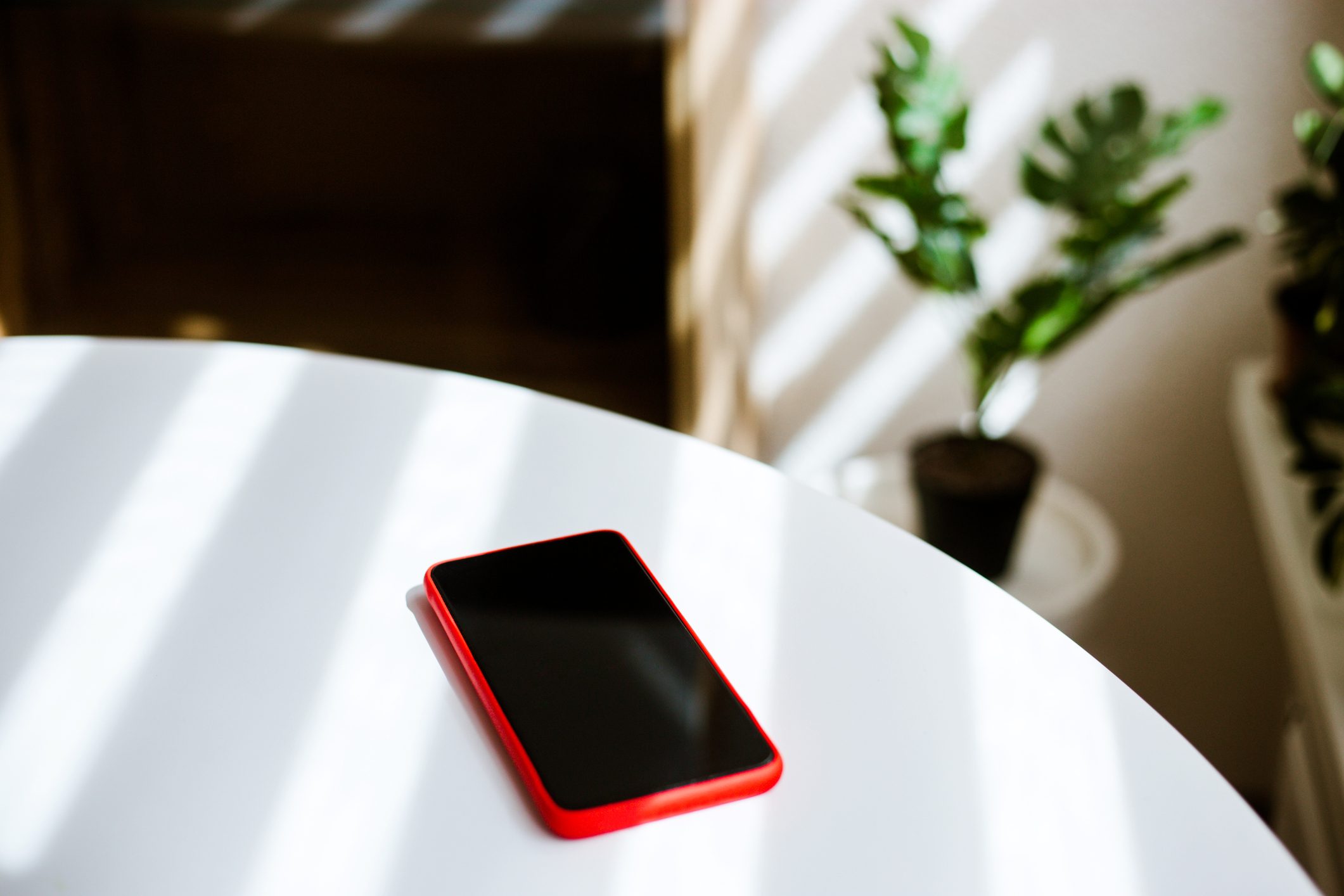 Mobile phone on white table.