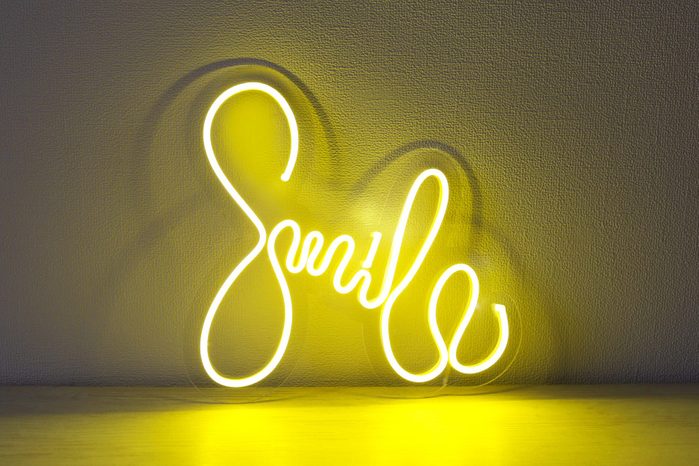 Yellow neon sign smile. Trendy style.