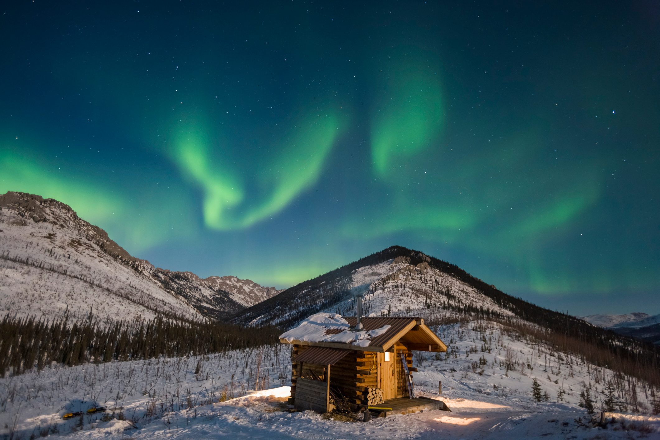 Aurora over Caribou Bluff log cabin.