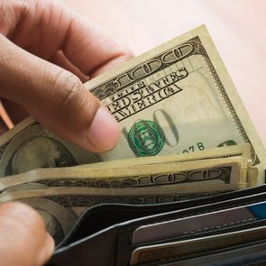 Mixed Race man taking money out of wallet