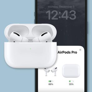 airpods and iphone showing airpods battery level