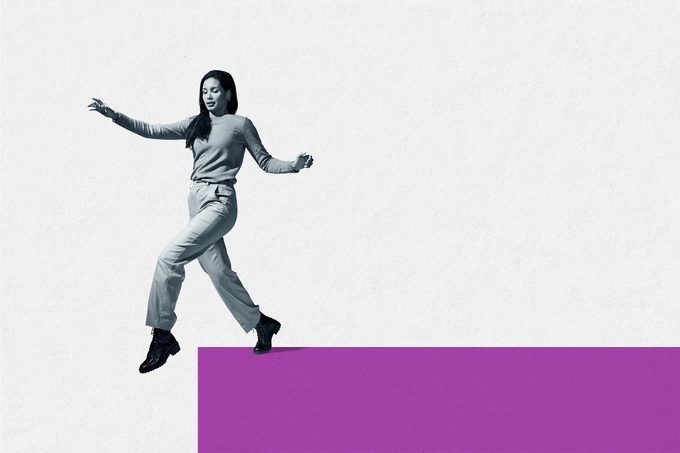 Woman about to take first step from block footpath