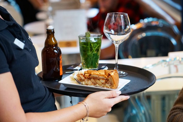 The waitress brings the order on a tray.