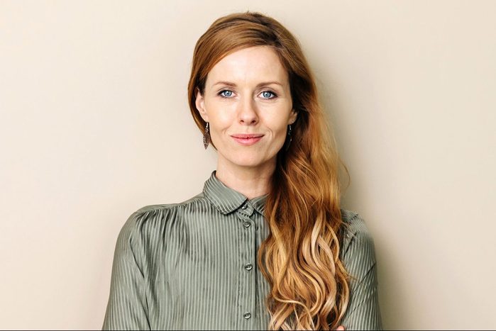 Businesswoman Smiling With Arms Folded