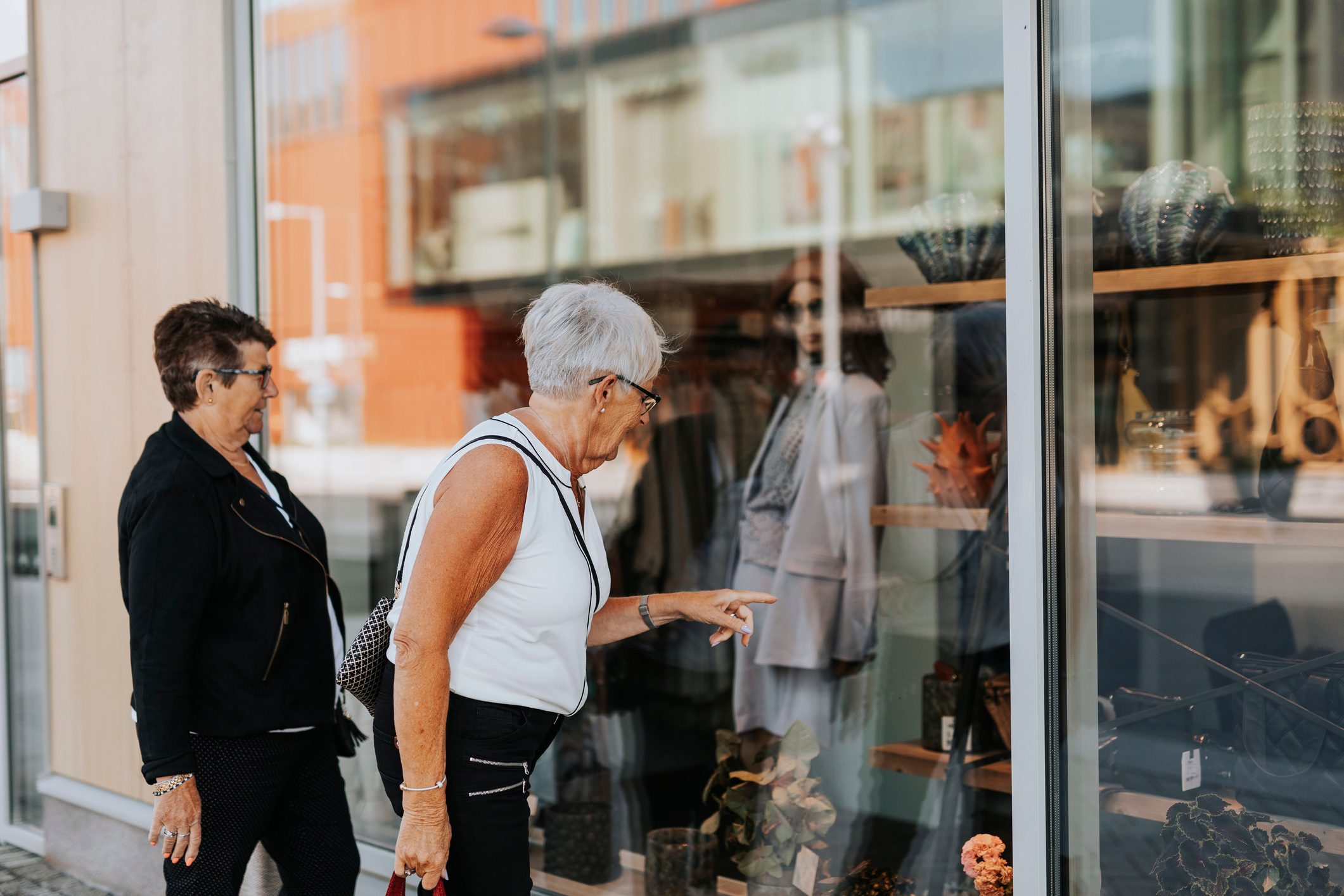 Senior women looking at shop window