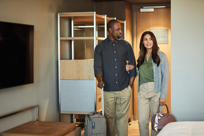 Couple arriving in hotel room during weekend