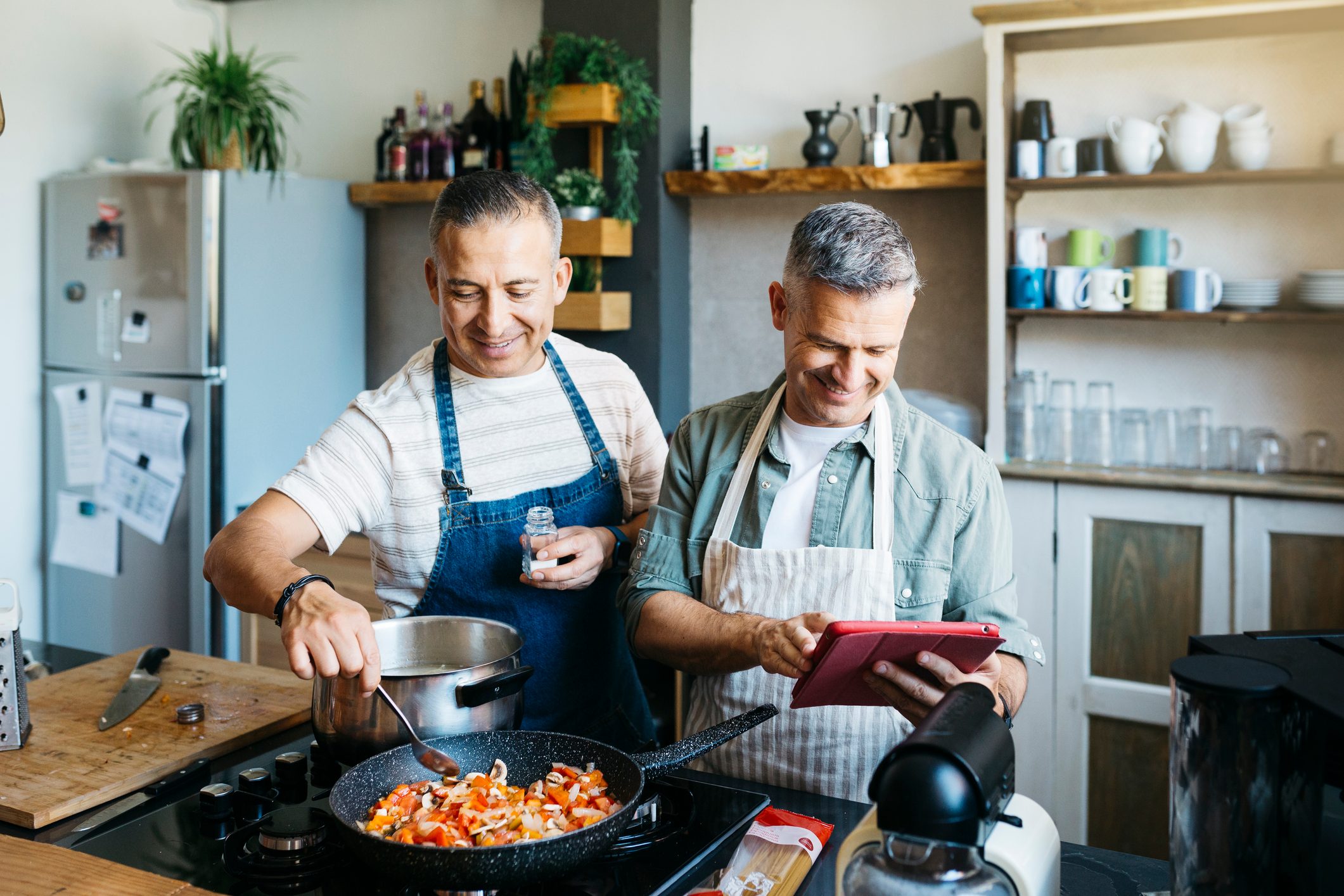 Gay couple cooking in a kitchen